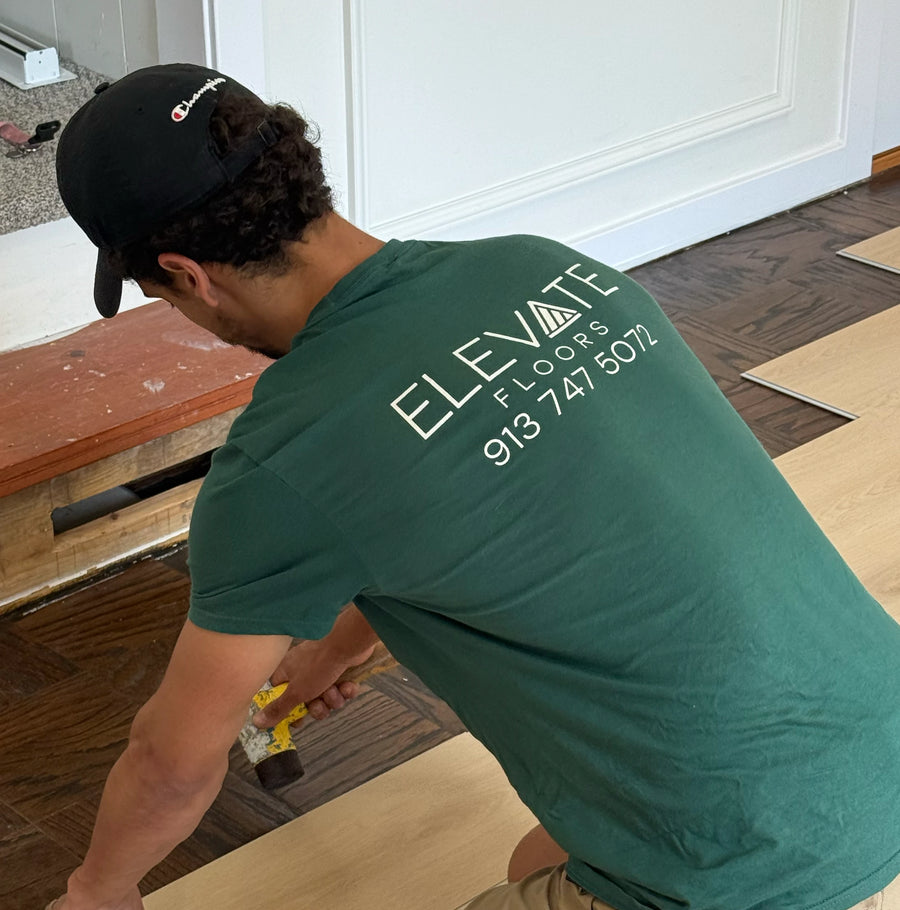 Installer nailing down a plank